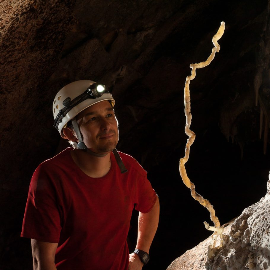 Caver looking at tall 'snake-dancer' helicite