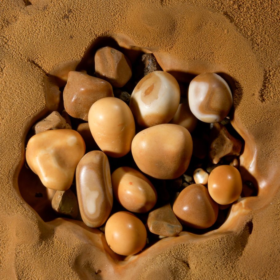 Nest of pristine cave pearls in the flowstone of a shallow cave pool