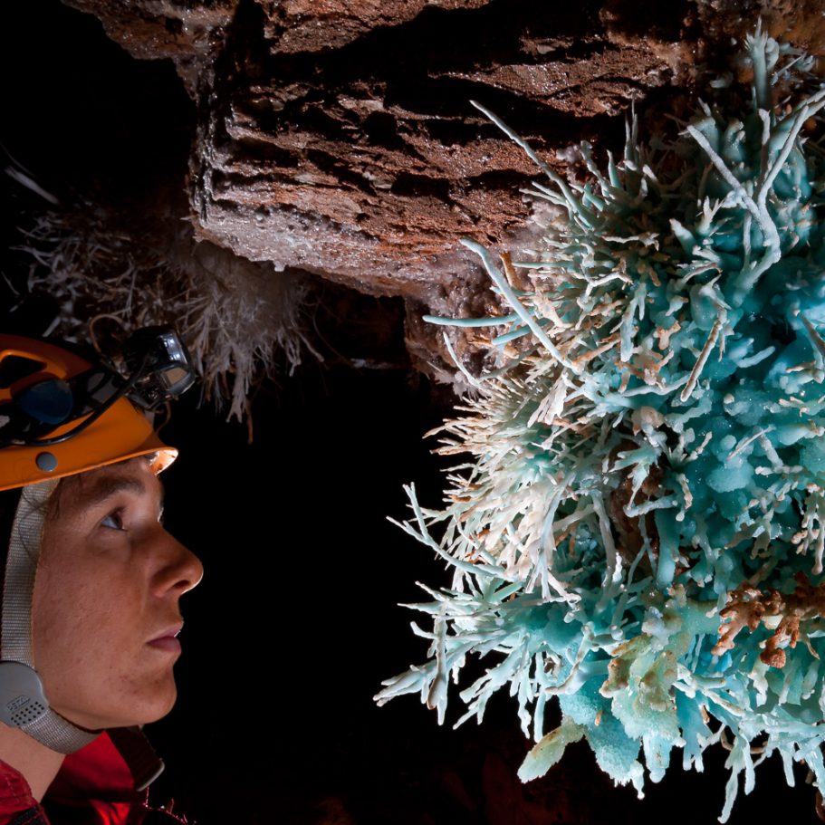 Caver admiring big cluster of blue aragonite helictites