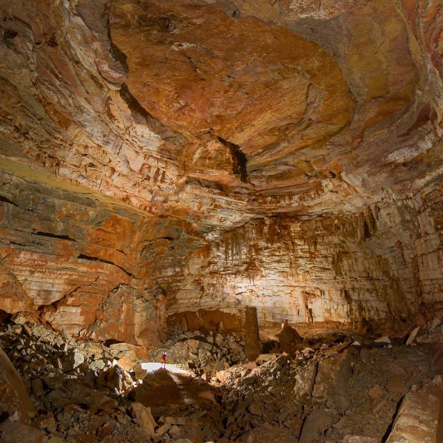 Giant cave chamber with several cavers for scale