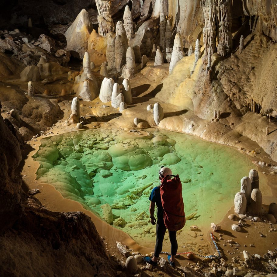Caver at crystal clear cave lake 'Pearlsian Gulf' in Lechuguilla Cave