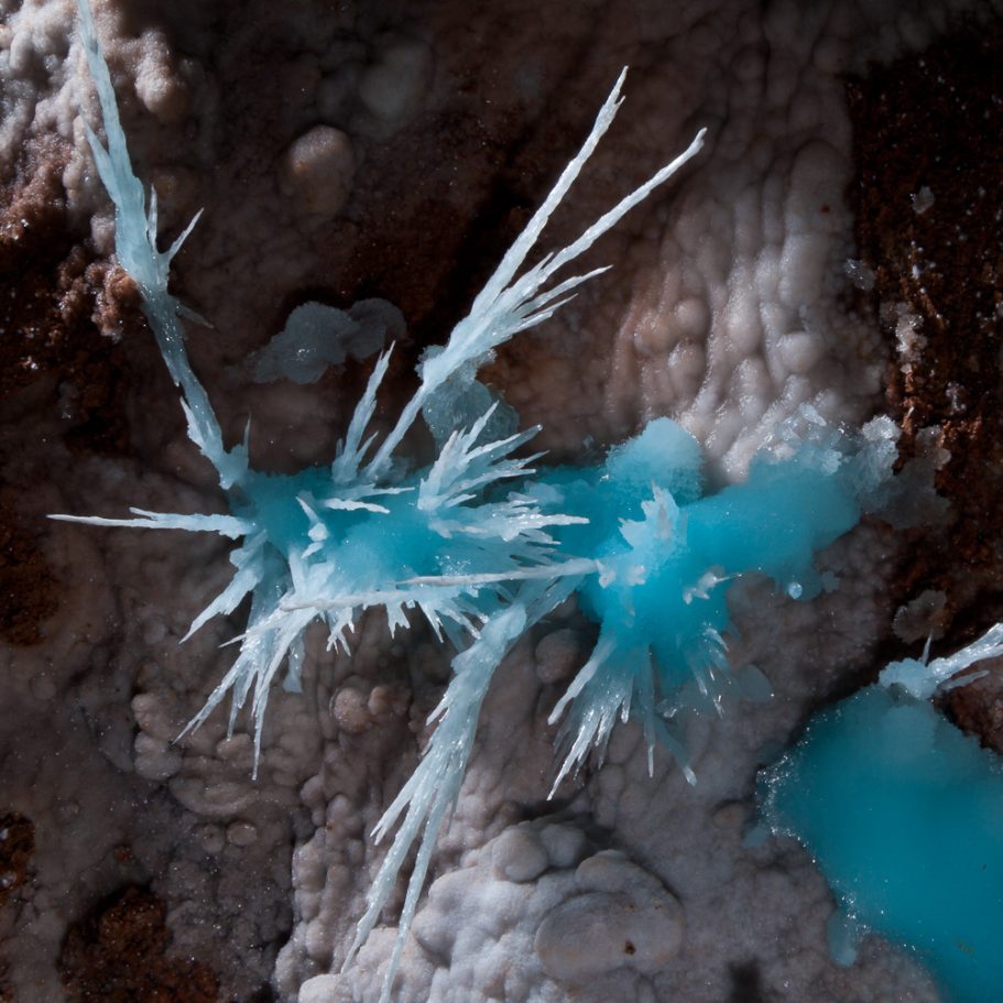 Radiating blue aragonite crystals on cave wall