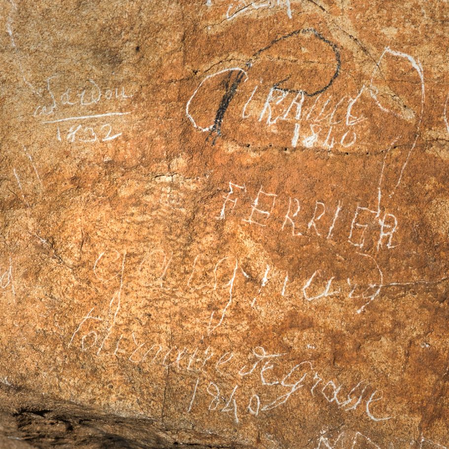 Inscriptions from the 19th century on teh wall of a cave