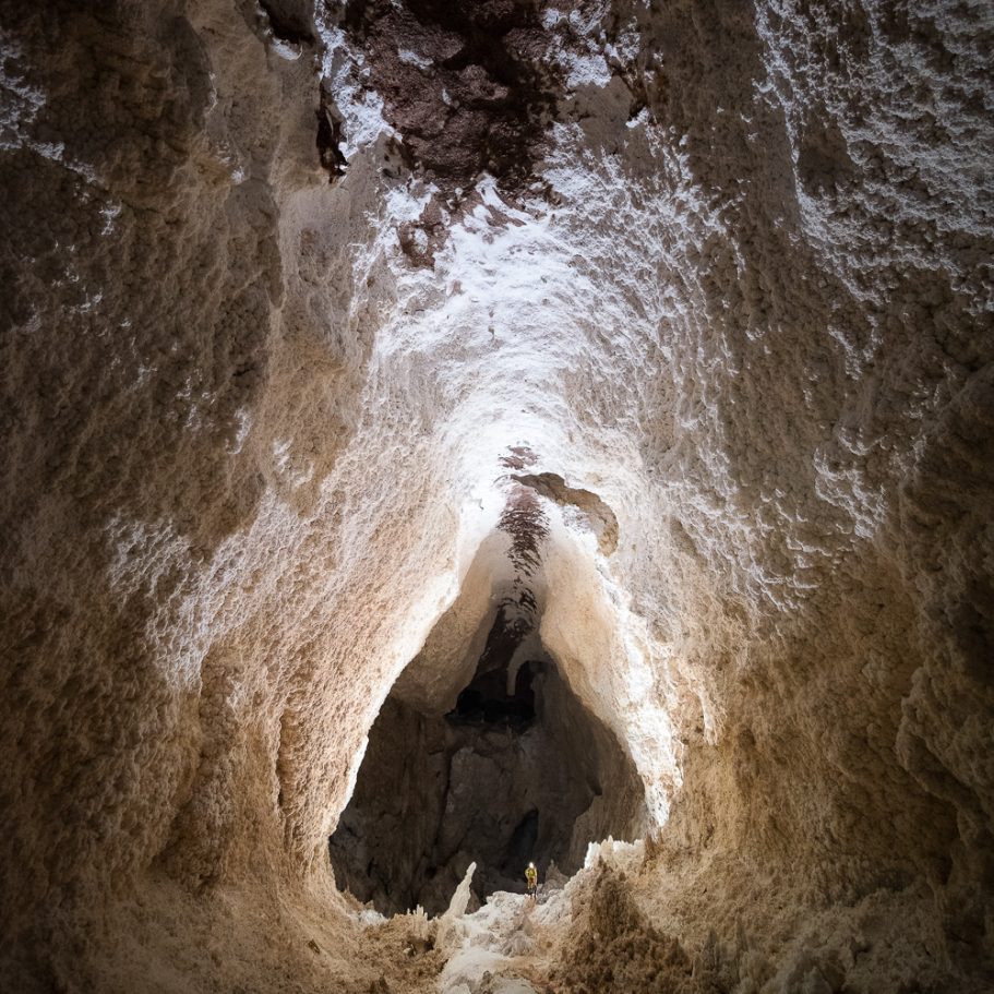 Large borehole-tape cave passage in Lechuguilla Cave; cave explorer for scale