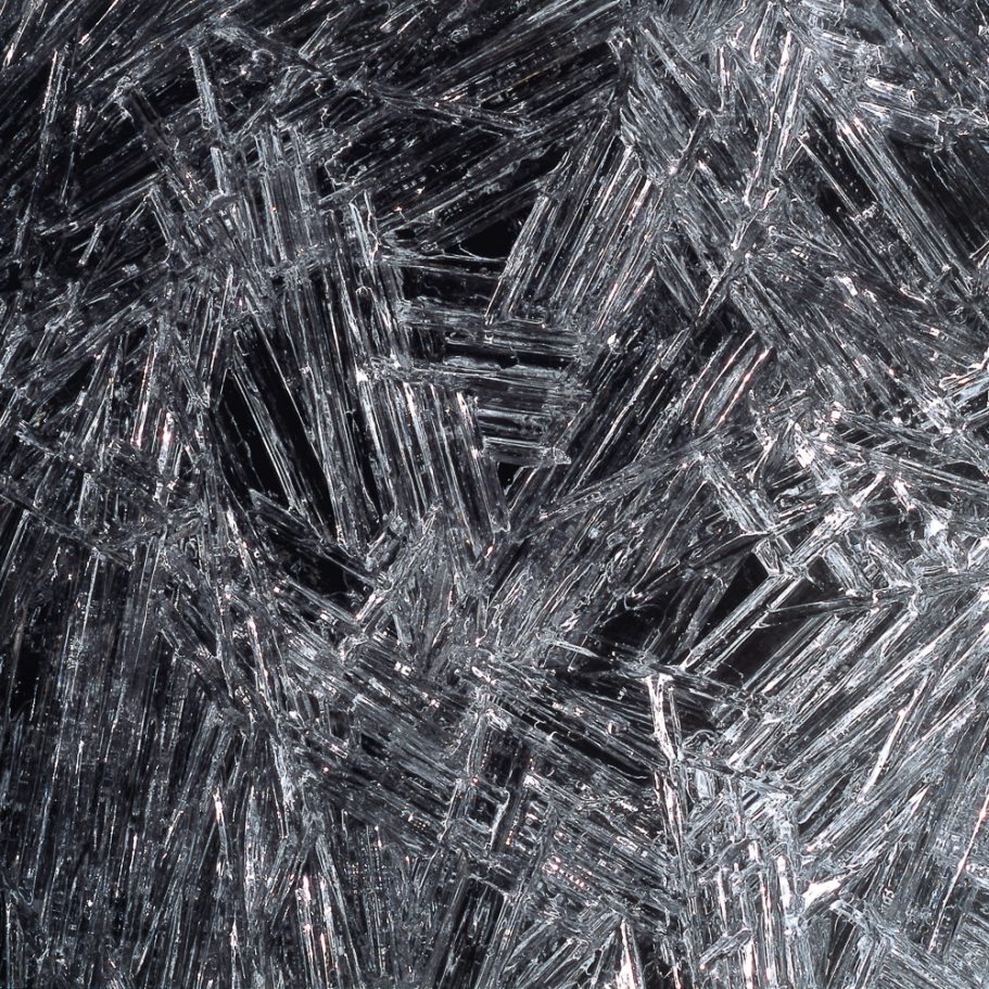 Close-up photo of ice crystals forming an ice floor in a cave