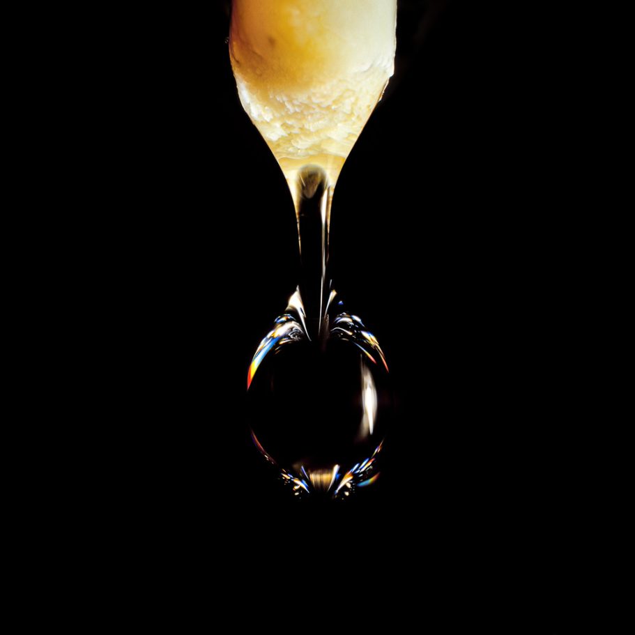 Water drop falling from the tip of a soda straw stalactite