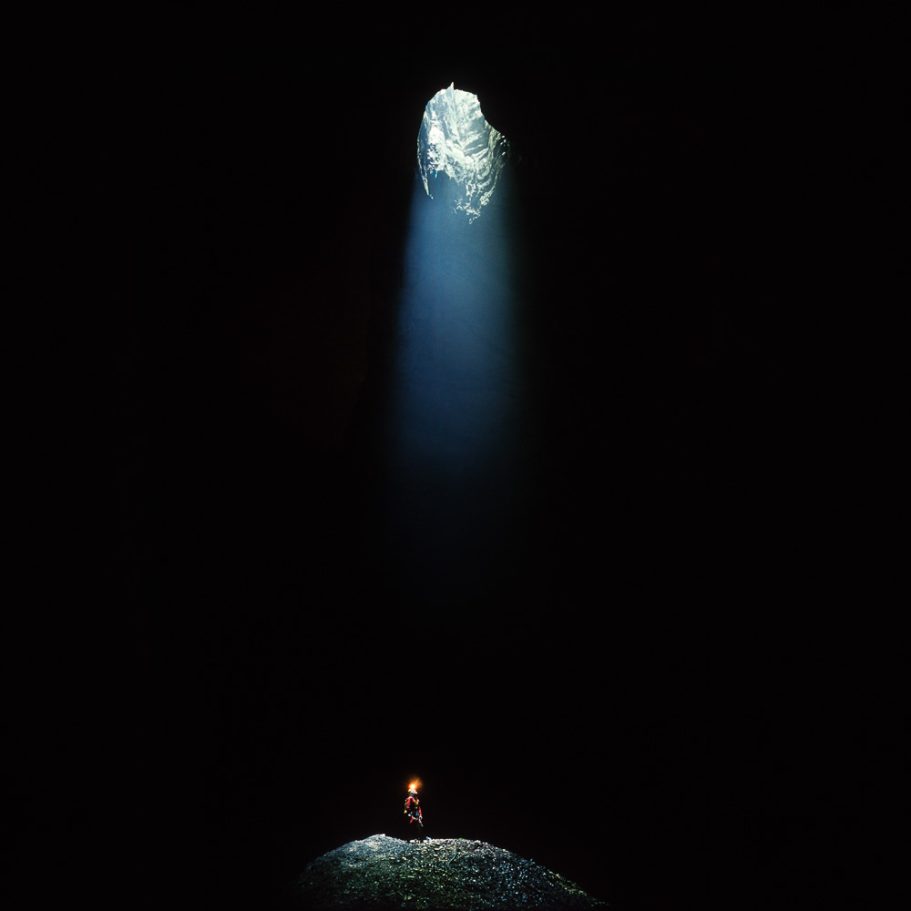 Caver below a skylight in the cave ceiling