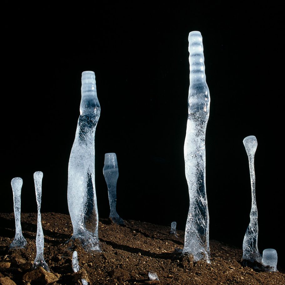 Cluster of several ice stalagmites growing in a cave