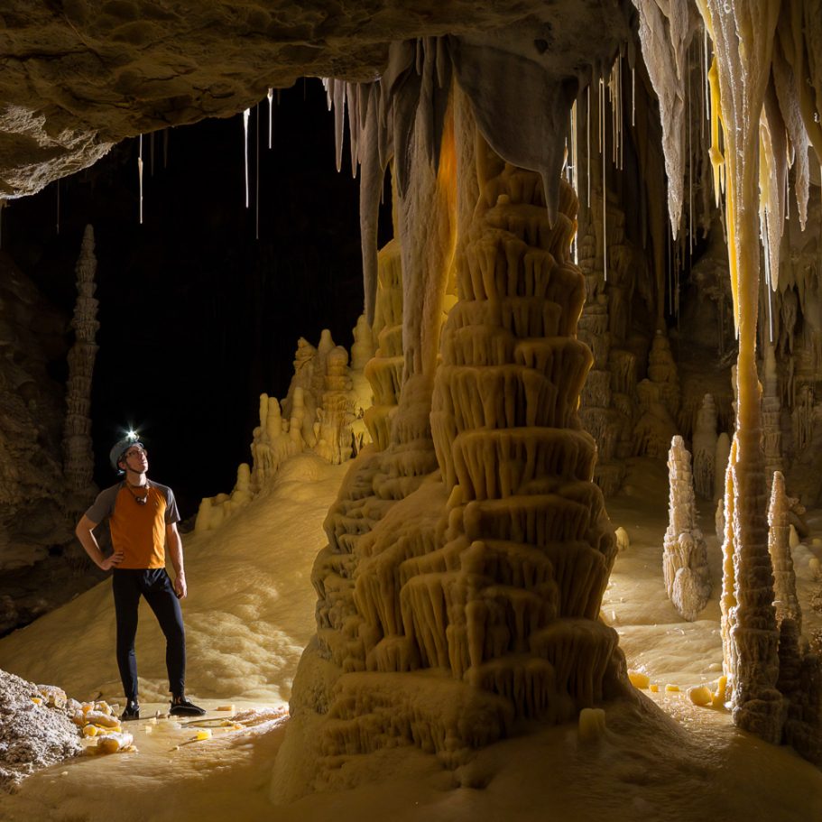 Cave explorer admiring pristine calcite formations in Lechuguilla Cave