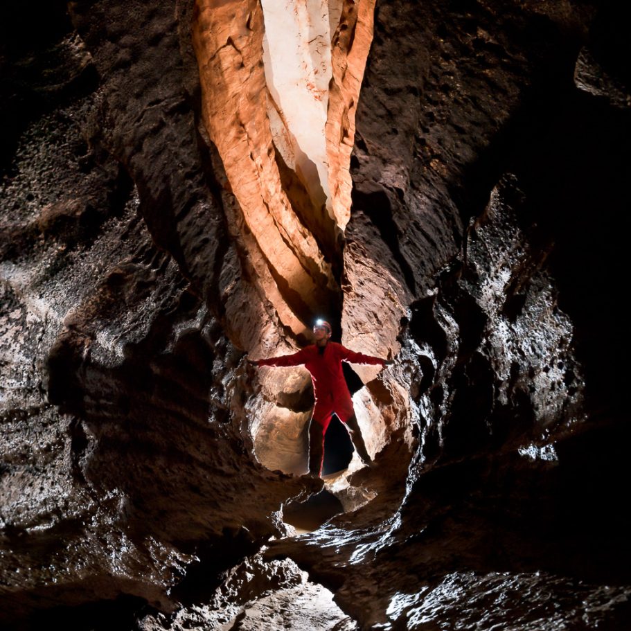Caver in high cave canyon