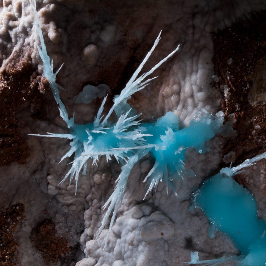 Radiating blue aragonite crystals on a cave wall